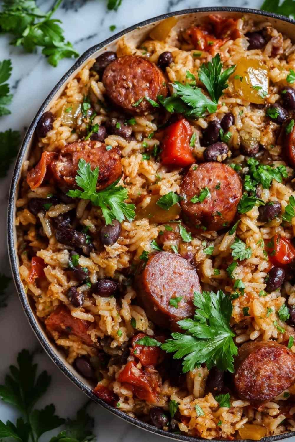 Black beans and rice with sausage in a large skillet garnished with fresh cilantro