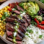 Cilantro lime steak bowls with sliced grilled flank steak, rice, black beans, corn, tomatoes, and avocado