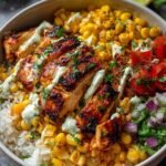Street Corn Chicken Rice Bowl with charred corn, sliced chicken, cotija cheese and fresh cilantro